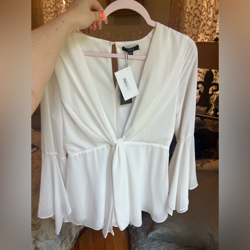 White Romper with Bell Sleeves, a Deep V Cut, and tie detailing
